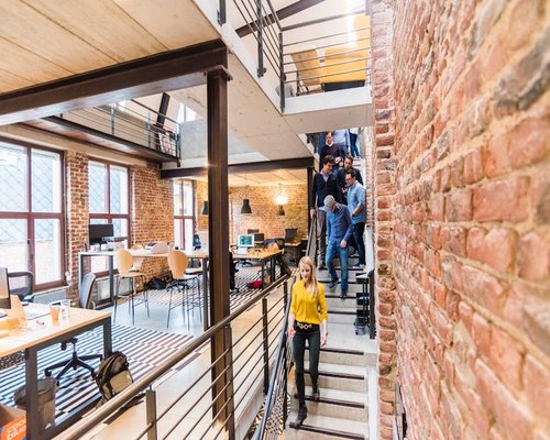 Modern office space with people standing and walking