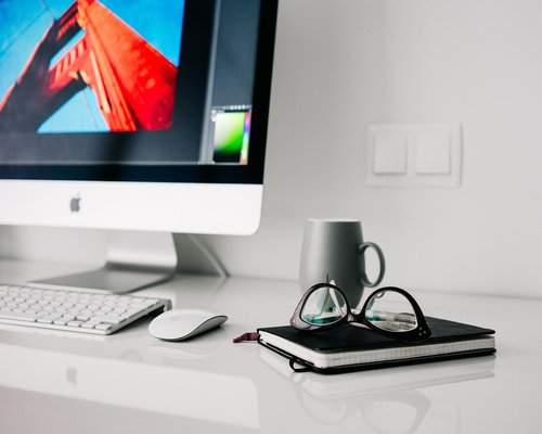 Person working comfortably from a home office desk with natural light