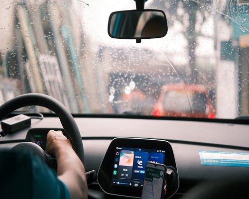 A steering wheel and traffic jam viewed from inside a car